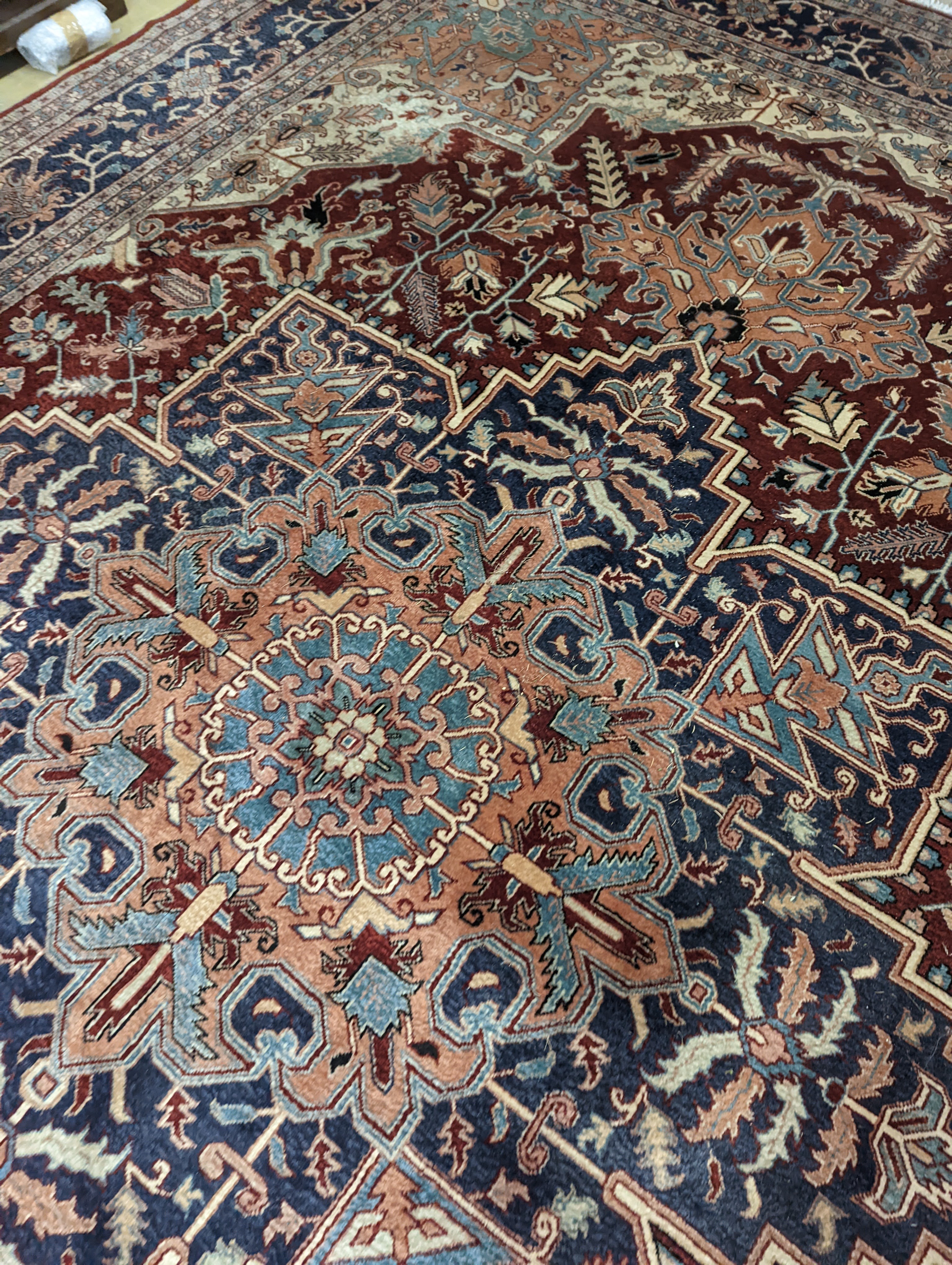 A large Caucasian style red ground carpet, 460 x 330cm